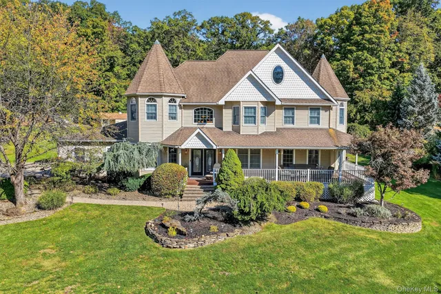 a front view of a house with a yard table and chairs