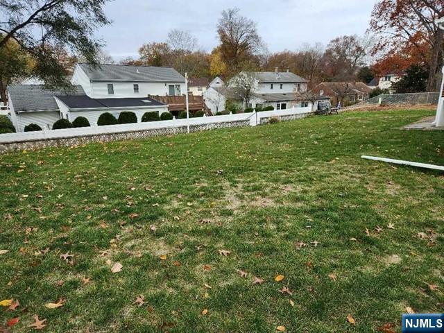 467 Spring Valley Road Paramus, NJ 07652 - Photo 16 of 20 a view of a big yard with plants and a building in the background