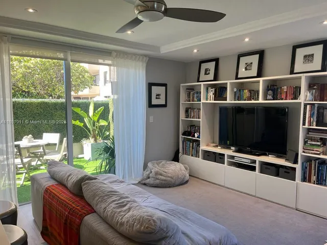 a bedroom with furniture and a flat screen tv