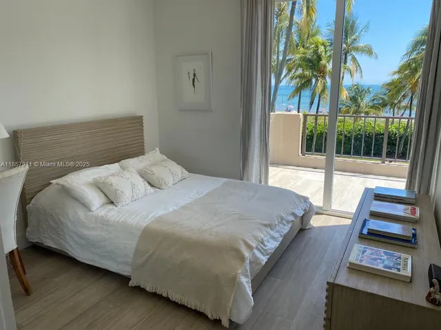 a bedroom with a bed and a potted plant
