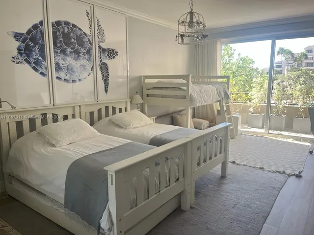 a spacious bedroom with two beds and a window