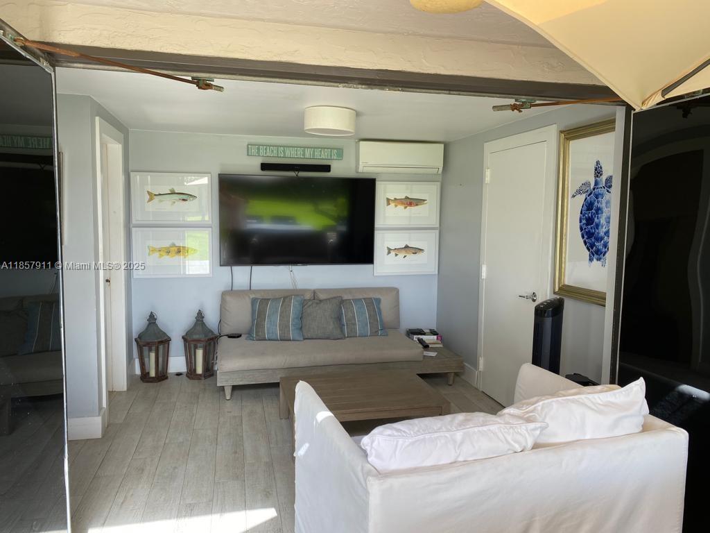 201 Crandon Boulevard, Unit 177 Key Biscayne, FL 33149 - Photo 20 of 24 a living room with furniture and a flat screen tv