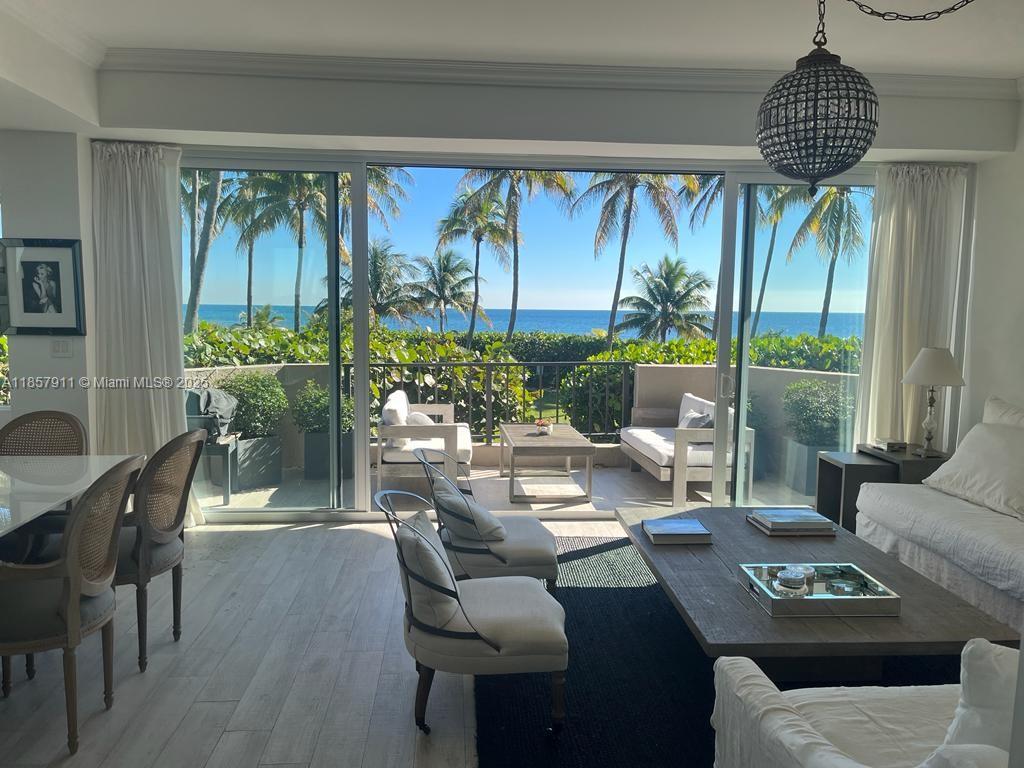 201 Crandon Boulevard, Unit 177 Key Biscayne, FL 33149 - Photo 2 of 24 a living room with furniture and a large window