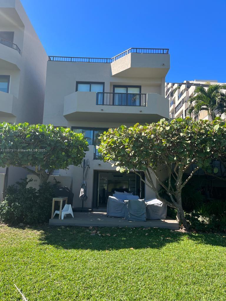 201 Crandon Boulevard, Unit 177 Key Biscayne, FL 33149 - Photo 24 of 24 a view of a house with a yard and a garden