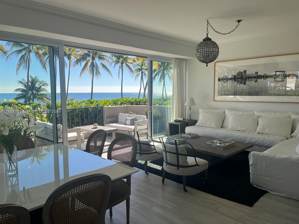 201 Crandon Boulevard, Unit 177 Key Biscayne, FL 33149 - Photo 7 of 24 a living room with furniture and a large window