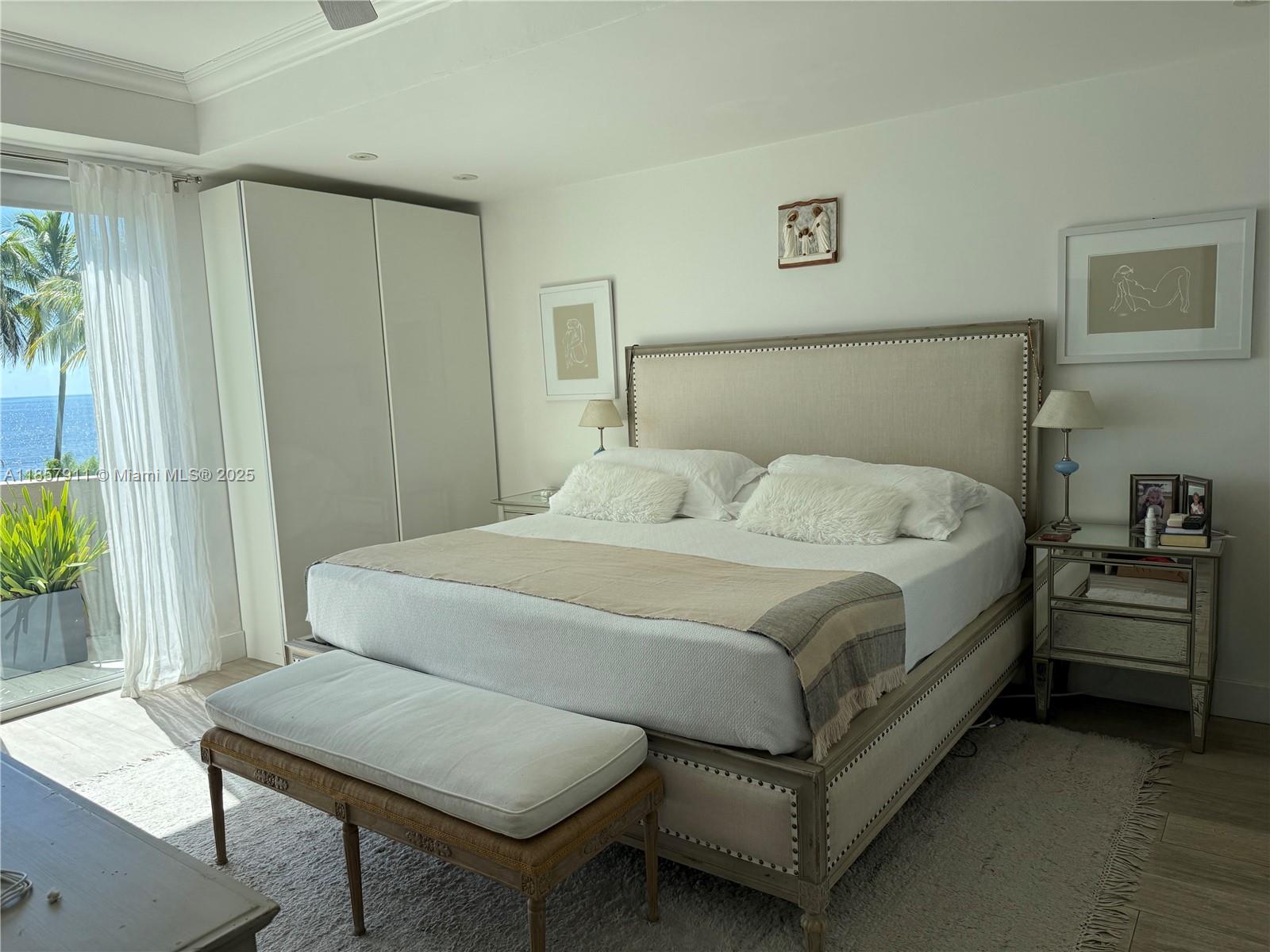 201 Crandon Boulevard, Unit 177 Key Biscayne, FL 33149 - Photo 8 of 24 a bedroom with a bed and a table in it