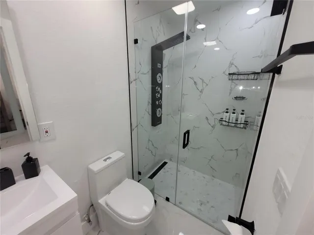 a white toilet sitting next to a bathroom sink