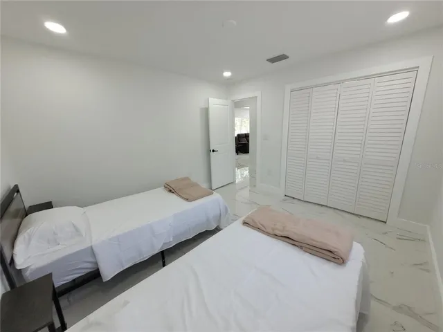 a bedroom with a bed and window