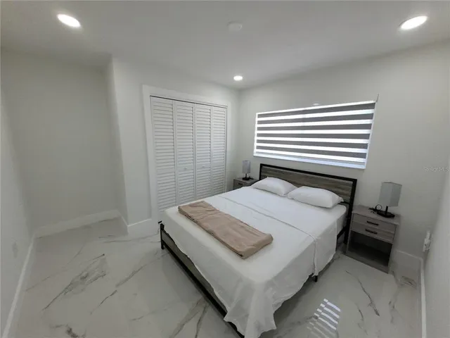 a bedroom with a bed and a window