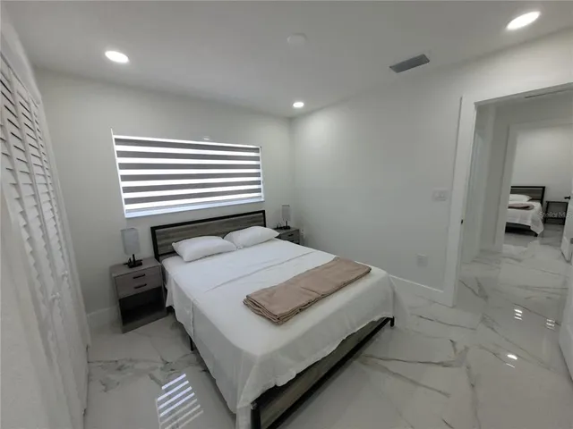 a bedroom with a bed and a table in it
