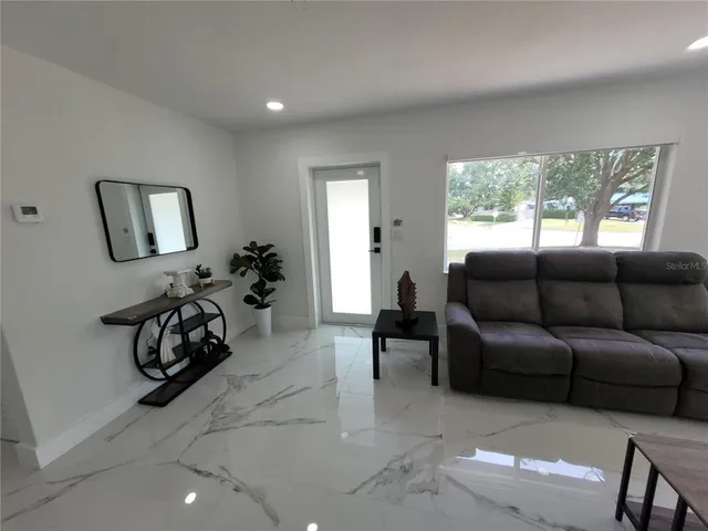 a living room with furniture and a large window
