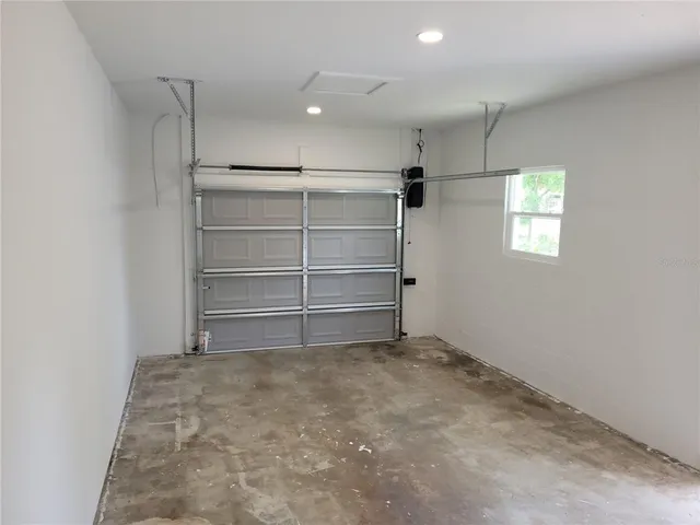 an empty room with a empty space and windows