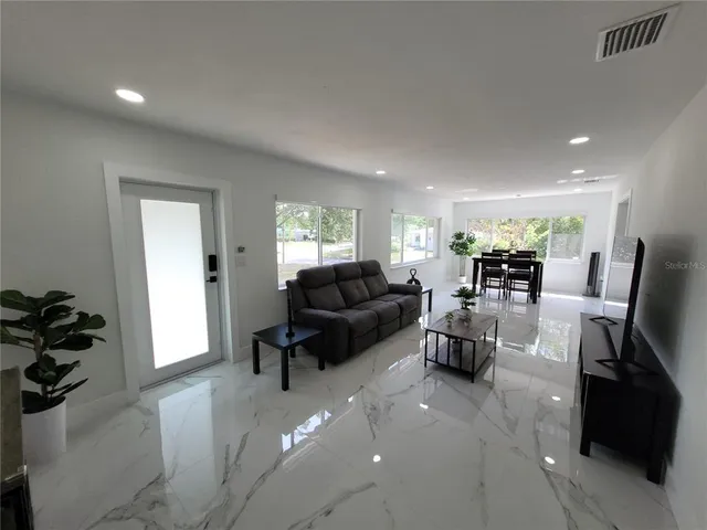 a living room with furniture and a large window