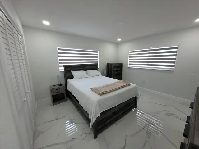 a bedroom with a bed and a window