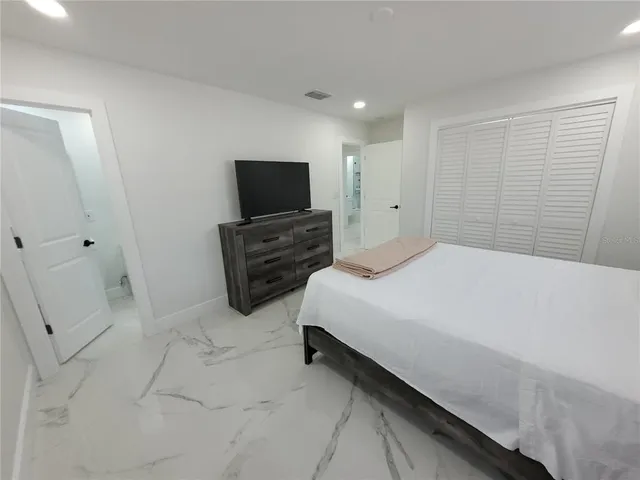 a bedroom with a bed and television