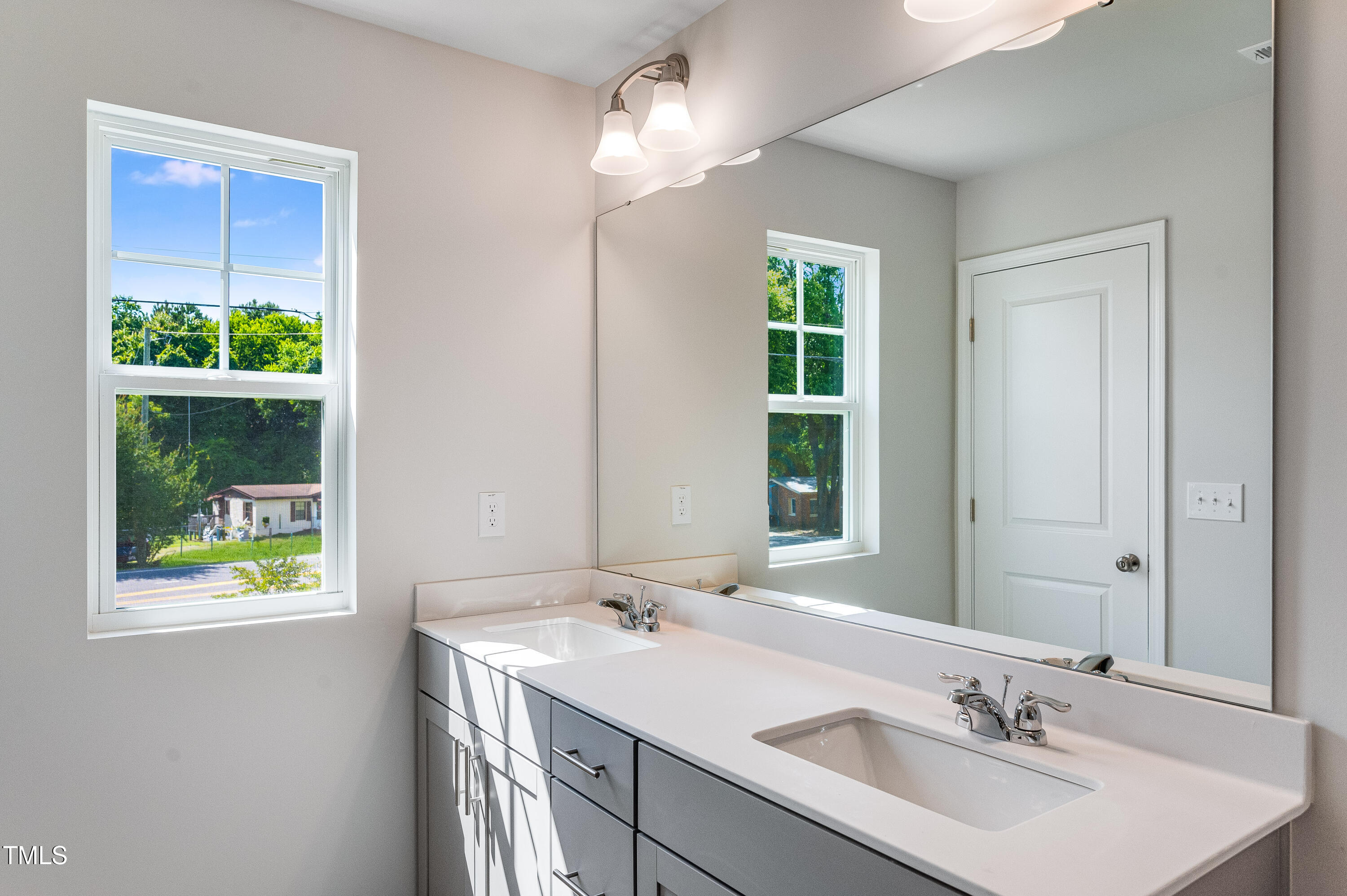 2206 Titanium Rock Road Durham, NC 27704 - Photo 23 of 27 a bathroom with a sink and a mirror