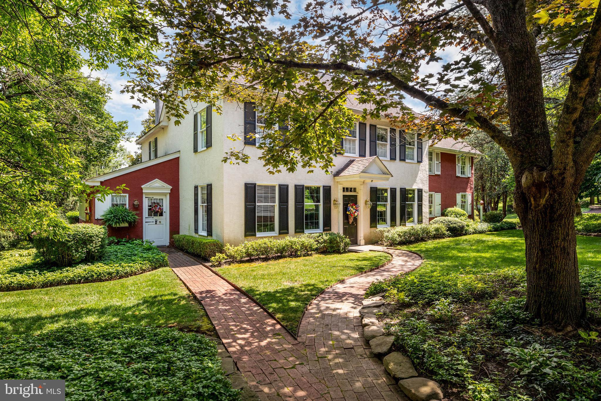 a front view of a house with yard and green space