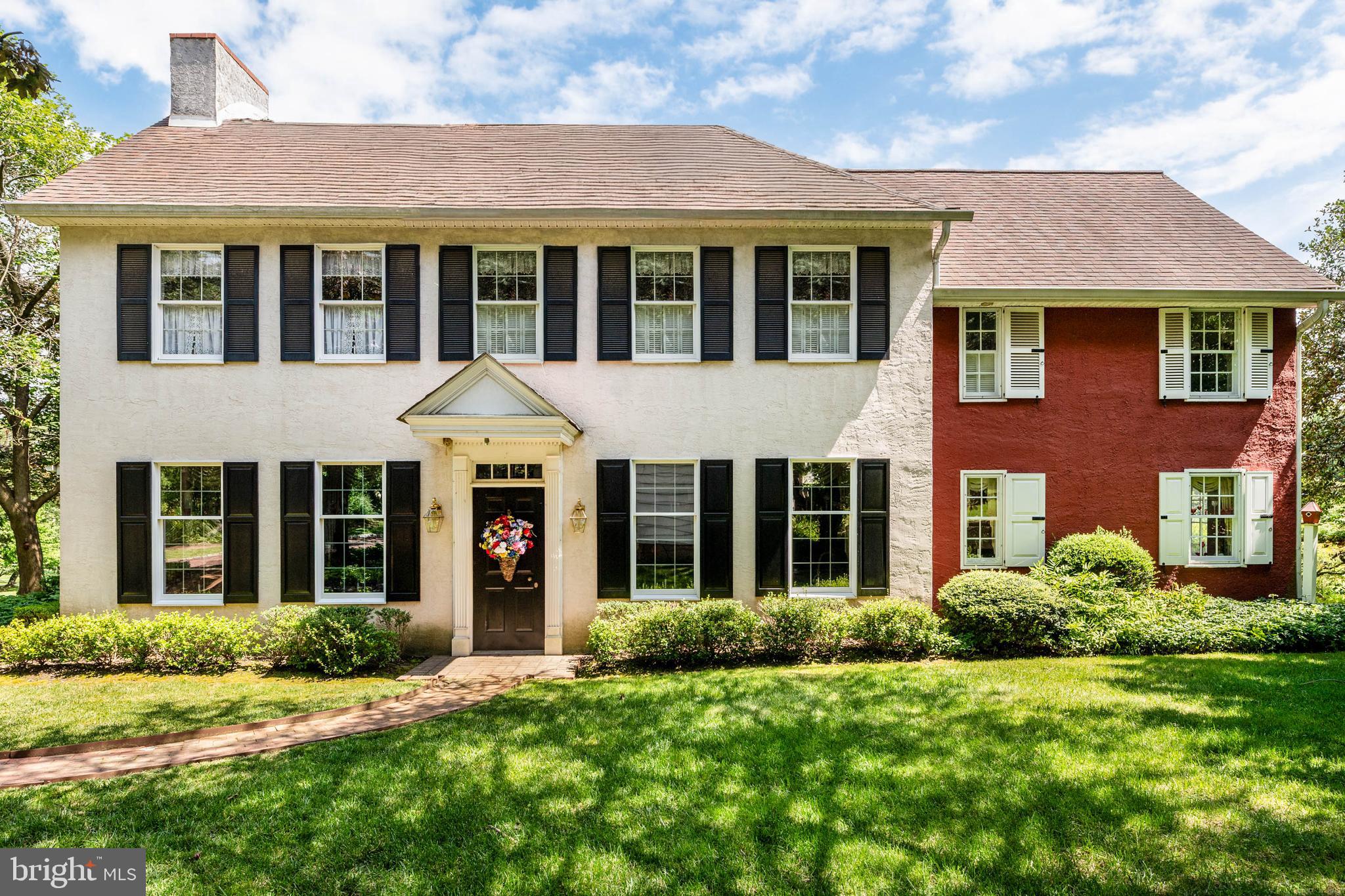 2070 Huntingdon Road Huntingdon Valley, PA 19006 - Photo 4 of 76 a view of a brick house with a yard plants and large tree