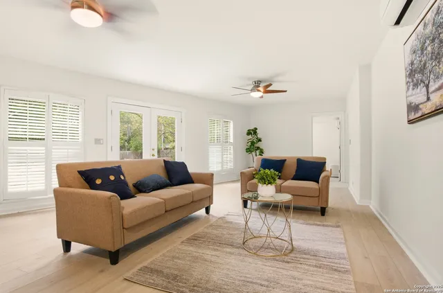 a living room with furniture and wooden floor