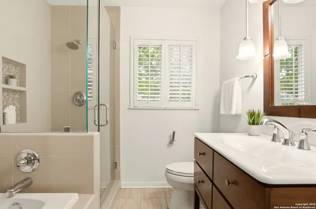 a bathroom with a sink toilet and shower