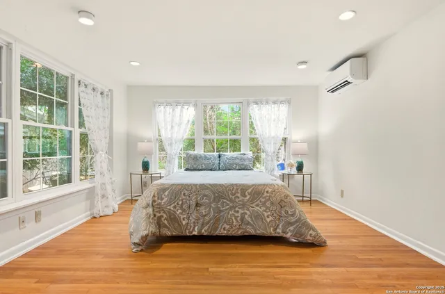 a bedroom with a bed and a large window