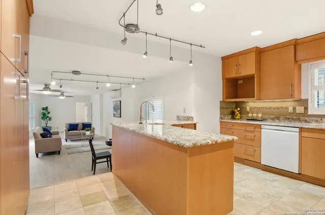 a large white kitchen with a large window