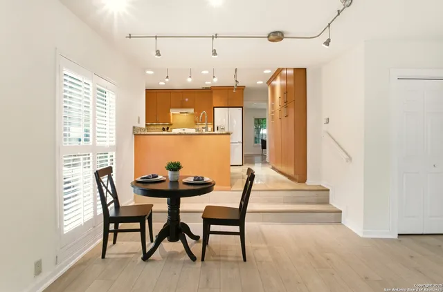 a dining room with furniture and wooden floor