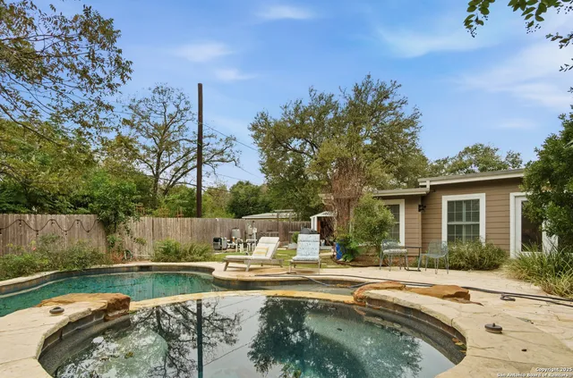 a view of a swimming pool with a patio