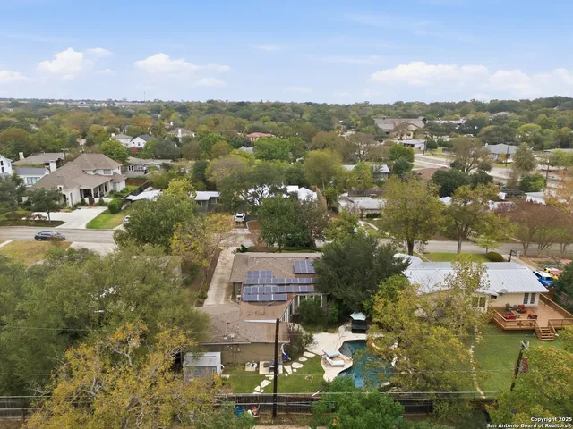 an aerial view of residential building with green space