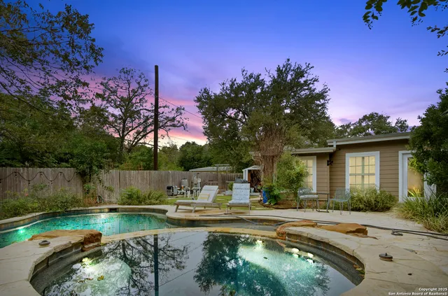 a view of a backyard with a swimming pool