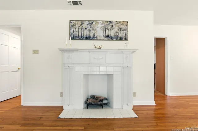 a view of living room with furniture and wooden floor