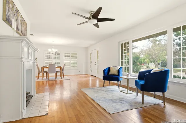 a living room with furniture and a table with wooden floor