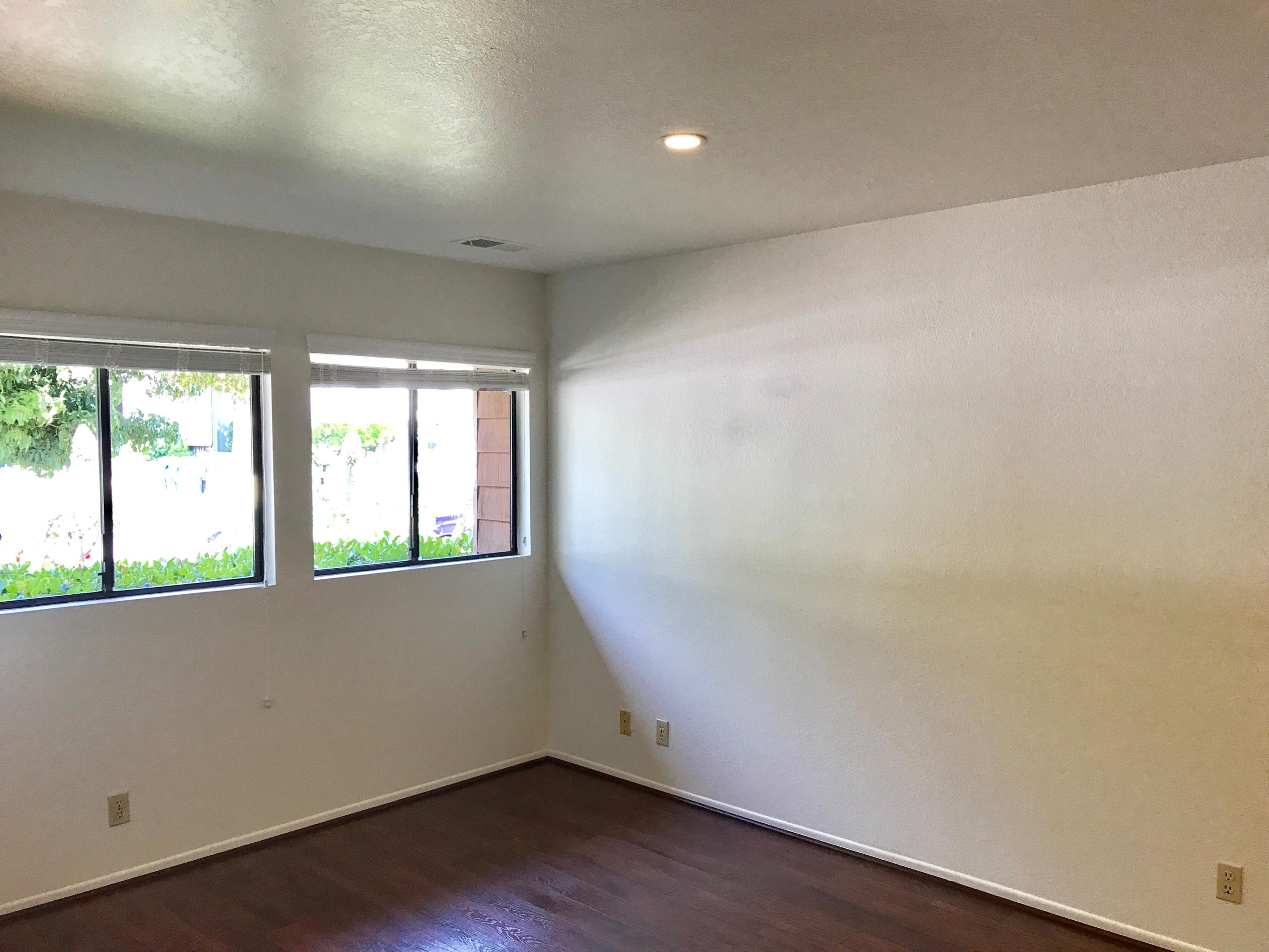 1815 Bath Street, Unit 1 Santa Barbara, CA 93101 - Photo 5 of 19 an empty room with wooden floor and windows