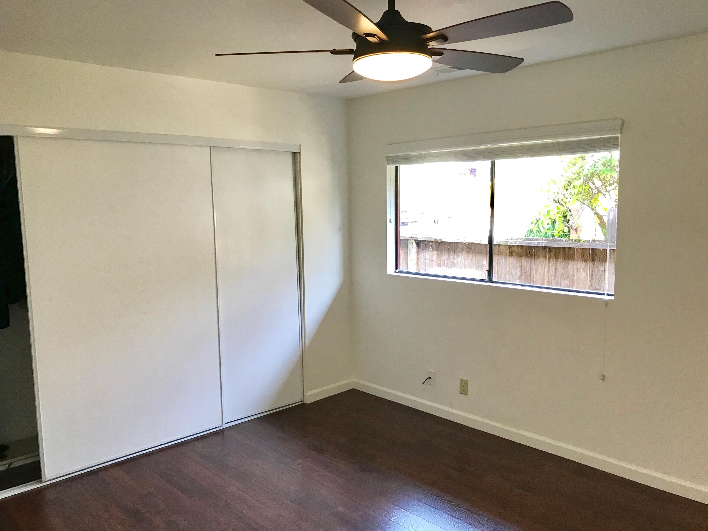 1815 Bath Street, Unit 1 Santa Barbara, CA 93101 - Photo 6 of 19 an empty room with a window and wooden floor