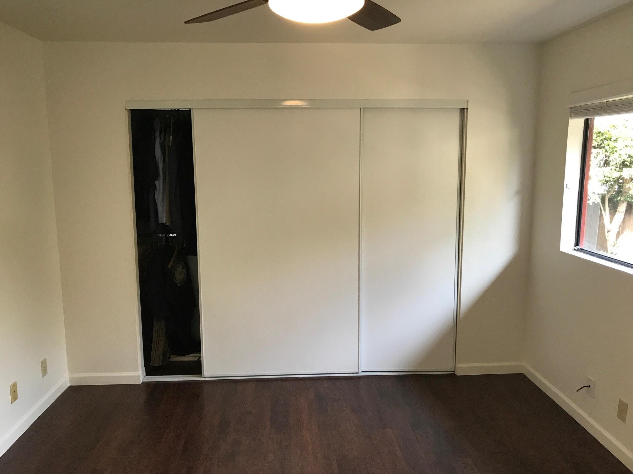 1815 Bath Street, Unit 1 Santa Barbara, CA 93101 - Photo 8 of 19 an empty room with wooden floor closet and windows