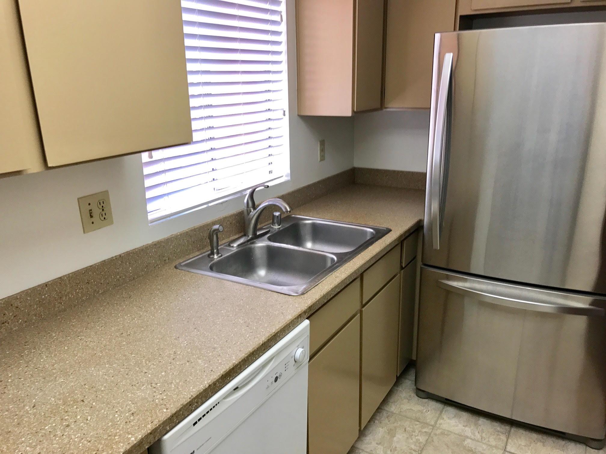 1815 Bath Street, Unit 1 Santa Barbara, CA 93101 - Photo 9 of 19 a kitchen with stainless steel appliances granite countertop a sink and a refrigerator