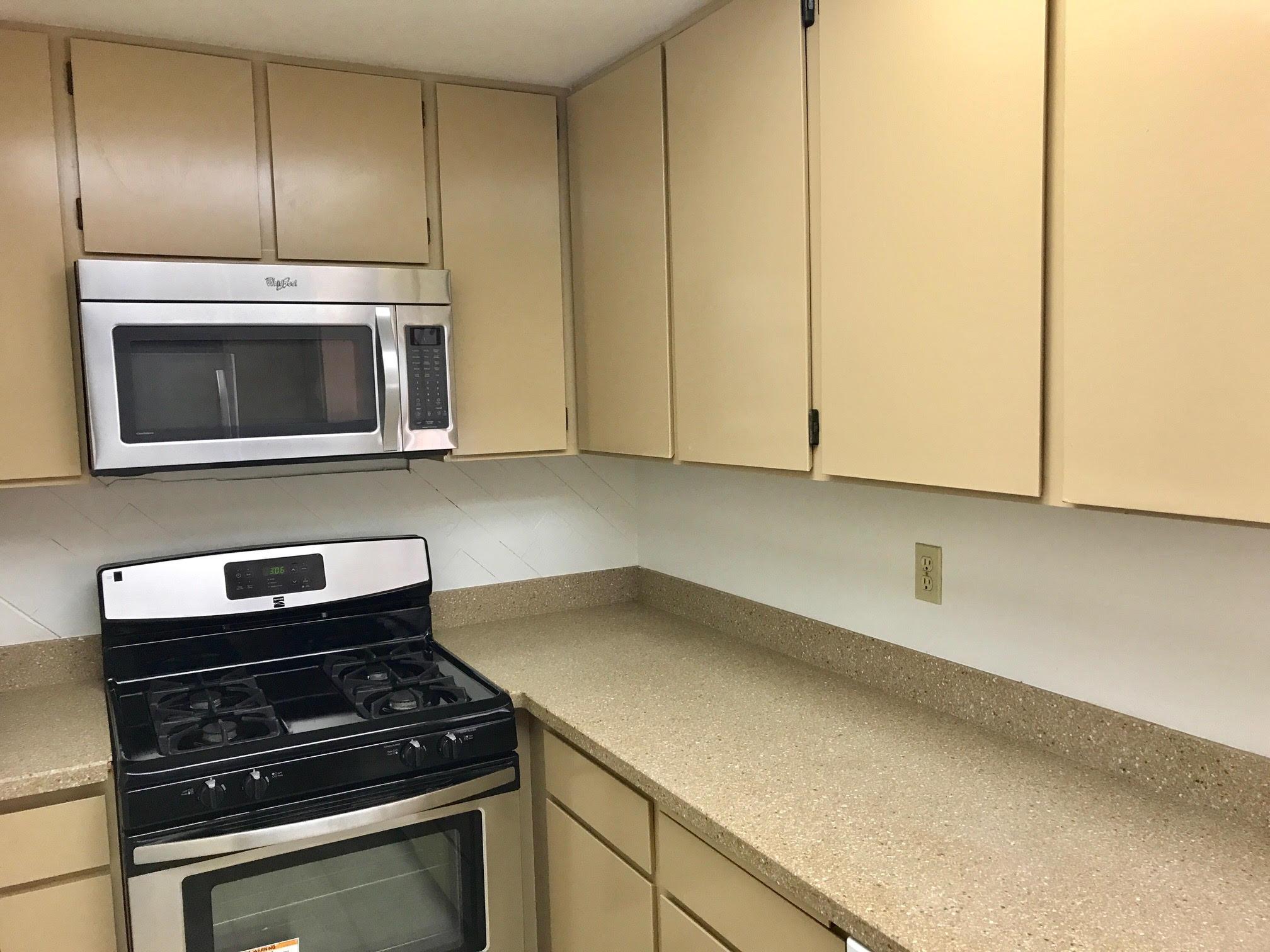 1815 Bath Street, Unit 1 Santa Barbara, CA 93101 - Photo 10 of 19 a kitchen with a stove and a microwave