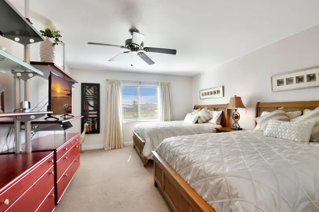 a bedroom with bed and a large window