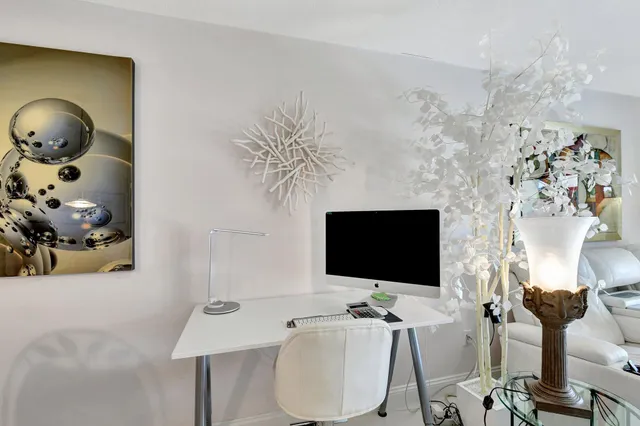 a view of a workspace with furniture and a flat screen tv