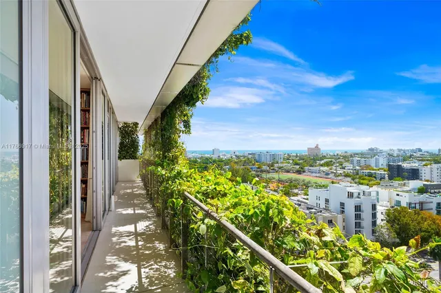 a living room with stainless steel appliances kitchen island furniture and a wooden floor