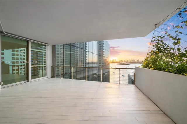 a bedroom with a large bed and a large window
