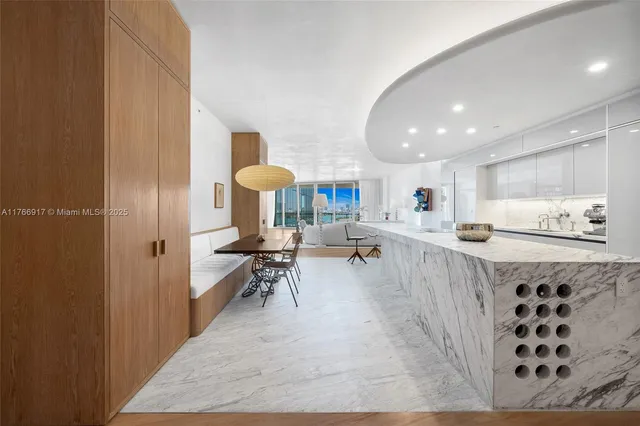 a kitchen with white cabinets and window