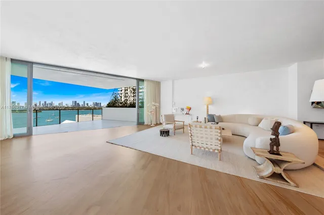 a bedroom with a large bed and a painting on the wall