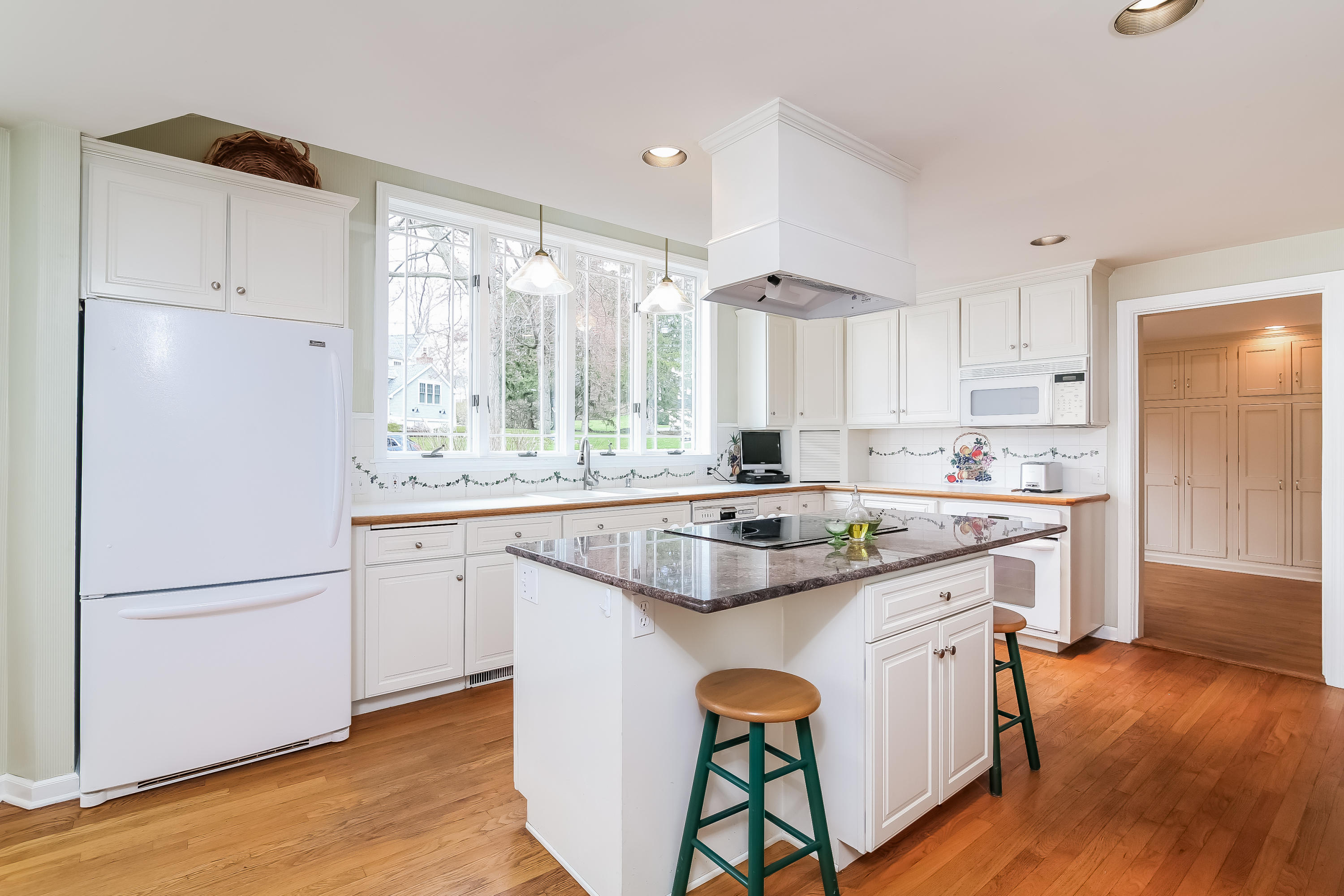 101 Colony Road Darien, CT 06820 - Photo 8 of 31 a kitchen with stainless steel appliances granite countertop a sink a stove a refrigerator and island with wooden floor