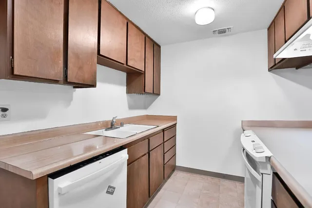 a kitchen with a sink cabinets and a window