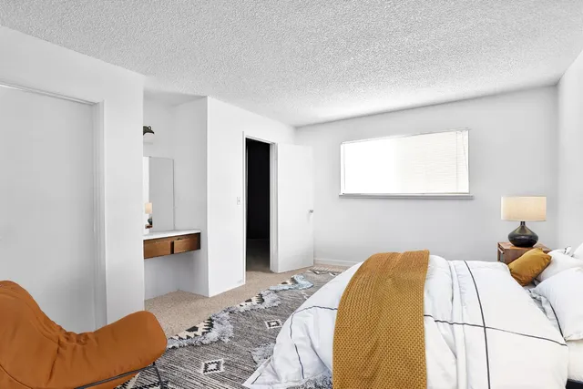 a bedroom with a bed and couch