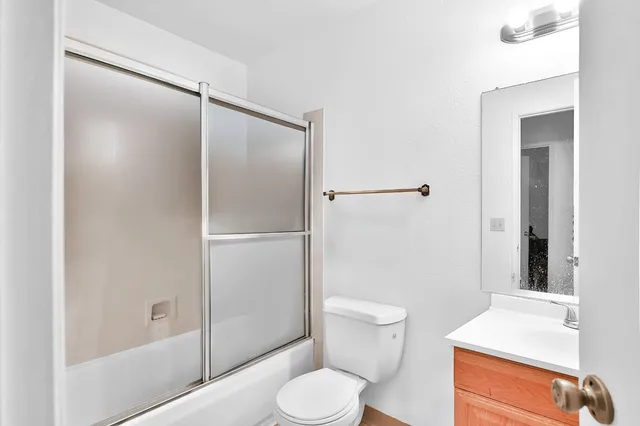 a white toilet sitting next to a bathroom sink
