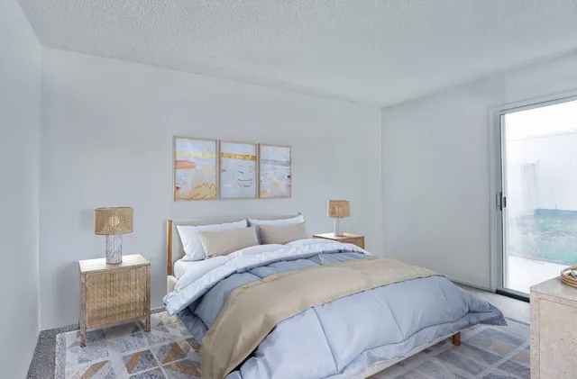 a bedroom with a bed and a painting on the wall