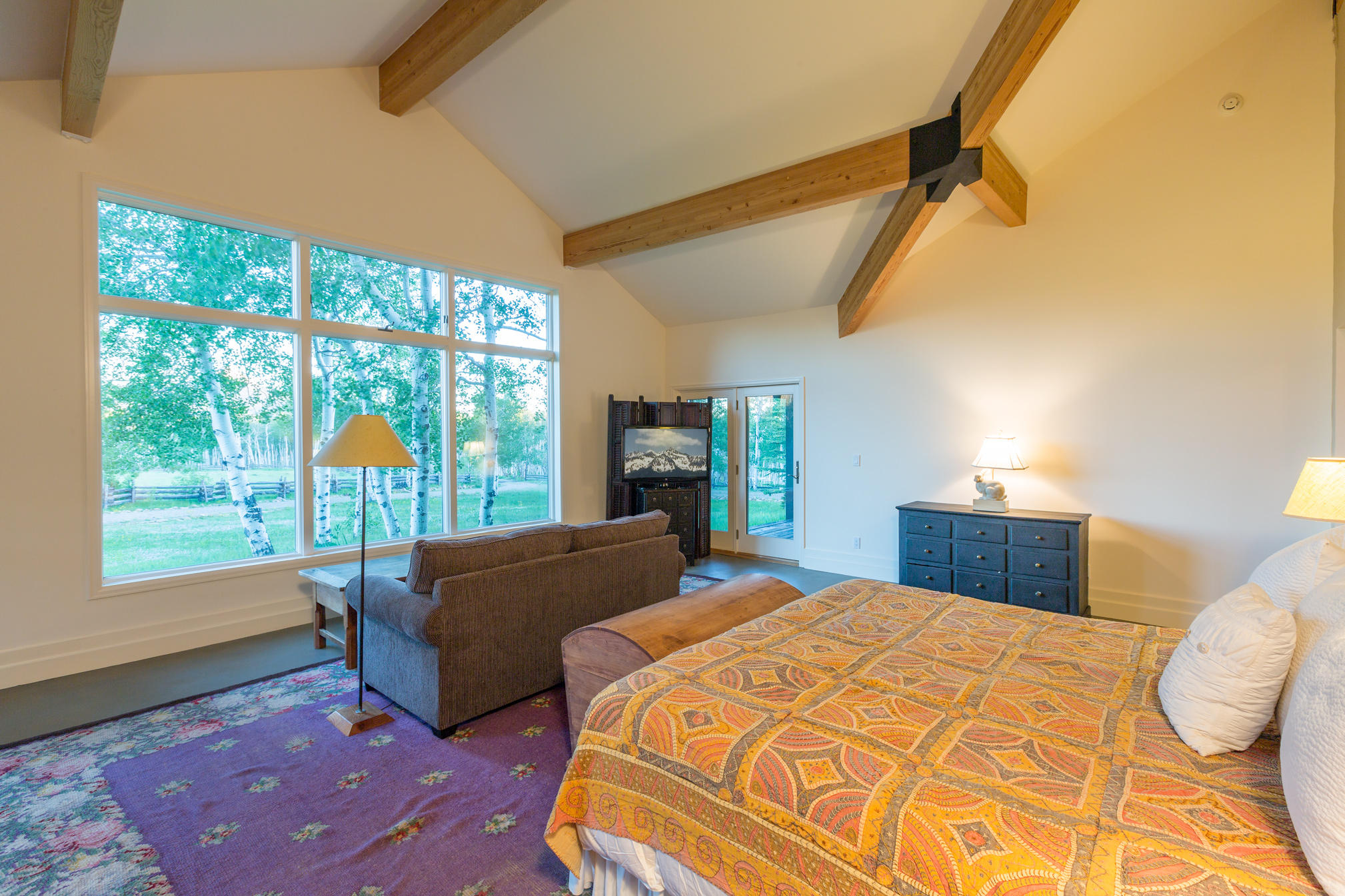 3289 Laughing Dog Road Placerville, CO 81430 - Photo 14 of 52 a bedroom with a bed and wooden floor