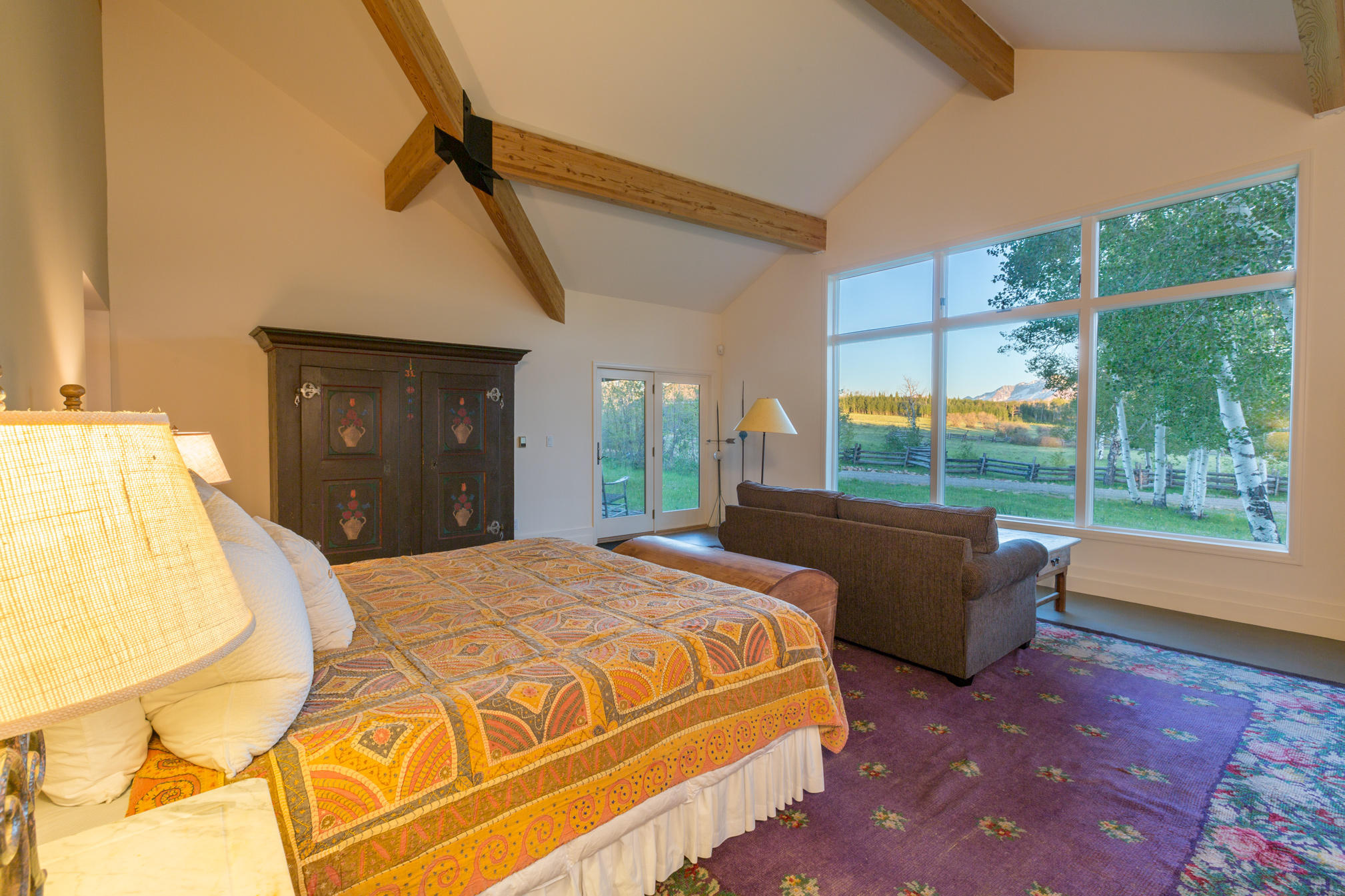 3289 Laughing Dog Road Placerville, CO 81430 - Photo 16 of 52 a bedroom with a bed and glass window